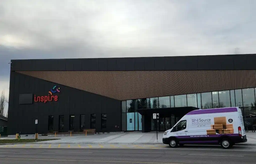 ONESource senior moving van parked at Inspire Library in Airdrie, supporting seniors and families with downsizing and relocation services.